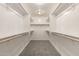 Organized walk-in closet with shelving and carpeted floor at 2000 N 36Th St # 29, Phoenix, AZ 85008