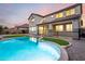 Backyard with a pool, patio, turf and pebble landscaping, and a block wall fence at 21472 E Saddle Ct, Queen Creek, AZ 85142