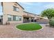 Spacious backyard with a well-maintained pool and surrounding artificial grass area for easy upkeep at 21472 E Saddle Ct, Queen Creek, AZ 85142