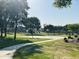 Outdoor basketball court in a community park setting, surrounded by trees and green space at 21472 E Saddle Ct, Queen Creek, AZ 85142
