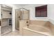 Spacious bathroom features a separate tub and walk-in shower with tiled surround at 21472 E Saddle Ct, Queen Creek, AZ 85142