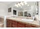 Bathroom featuring a large mirror, dual sinks, and wood cabinets at 21472 E Saddle Ct, Queen Creek, AZ 85142