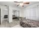 Spacious bedroom with mirrored closet, ceiling fan, and light wood floors at 21472 E Saddle Ct, Queen Creek, AZ 85142