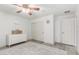 Bedroom with white walls, wood-look floors, white dresser, closet, and gray rug at 21472 E Saddle Ct, Queen Creek, AZ 85142