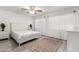 Bright bedroom with a white bed set, ceiling fan, and lots of natural light from large windows at 21472 E Saddle Ct, Queen Creek, AZ 85142