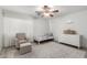 Bright bedroom with light walls, ceiling fan, chair, single bed, dresser, and gray rug at 21472 E Saddle Ct, Queen Creek, AZ 85142