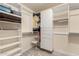 Walk-in closet featuring built-in shelves and drawers for ample storage space at 21472 E Saddle Ct, Queen Creek, AZ 85142