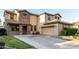 Beautiful two-story home featuring a two-car garage and stone accents around the entry and windows at 21472 E Saddle Ct, Queen Creek, AZ 85142
