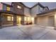 Inviting two-story home featuring a convenient two-car garage and stone accents around front door at 21472 E Saddle Ct, Queen Creek, AZ 85142