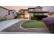 Charming two-story home with a well-manicured lawn, desert landscaping, and a spacious driveway at 21472 E Saddle Ct, Queen Creek, AZ 85142
