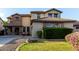 Eye-catching two-story home with stone detailing and a beautiful front yard with mature landscaping at 21472 E Saddle Ct, Queen Creek, AZ 85142
