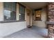 Inviting front porch area with a charming welcome mat and decorative wreath on the front door at 21472 E Saddle Ct, Queen Creek, AZ 85142
