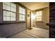 Cozy front porch area with a welcoming door and plenty of natural light from the windows at 21472 E Saddle Ct, Queen Creek, AZ 85142