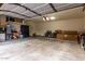 A spacious garage with storage shelves and ample parking space at 21472 E Saddle Ct, Queen Creek, AZ 85142