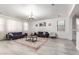 Spacious living room with a large rug, comfortable sofas, and bright natural light at 21472 E Saddle Ct, Queen Creek, AZ 85142