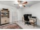 Home office with built-in shelving, work desk, and natural light at 21472 E Saddle Ct, Queen Creek, AZ 85142