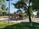 Community playground with modern equipment and shaded seating, surrounded by greenery at 21472 E Saddle Ct, Queen Creek, AZ 85142