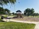 Community playground with slides, swings, and seating in a green, well-maintained area at 21472 E Saddle Ct, Queen Creek, AZ 85142