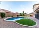 Enjoy the private backyard oasis with a sparkling pool, manicured turf, and desert landscaping at 21472 E Saddle Ct, Queen Creek, AZ 85142
