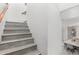 A view of the stairway with steps leading upwards and dining room with table and chairs off to the side at 21472 E Saddle Ct, Queen Creek, AZ 85142