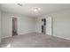 Large, gray bedroom with neutral carpet and three entry doors at 255 W Dewey Ave, Coolidge, AZ 85128