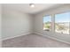 A carpeted bedroom featuring two large windows providing ample natural light at 255 W Dewey Ave, Coolidge, AZ 85128