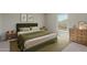 Cozy bedroom boasts comfortable bed, soft green accents, natural light and stylish decor at 255 W Dewey Ave, Coolidge, AZ 85128