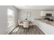 Charming dining area with modern table, seating for four, and natural light from the window at 255 W Dewey Ave, Coolidge, AZ 85128