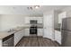 Kitchen with stainless steel appliances, granite countertops, and white cabinets at 255 W Dewey Ave, Coolidge, AZ 85128
