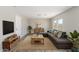 Inviting living room features a plush sectional sofa, wood accents and plenty of natural light at 255 W Dewey Ave, Coolidge, AZ 85128