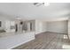 Open floor plan with laminate floors, connecting the living space to the kitchen area at 255 W Dewey Ave, Coolidge, AZ 85128