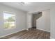 Living room featuring gray walls, vinyl floors, and a view of the front yard at 255 W Dewey Ave, Coolidge, AZ 85128