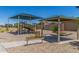Community playground with a covered picnic table and park bench at 255 W Dewey Ave, Coolidge, AZ 85128