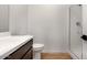 Bathroom featuring a sink, toilet, and shower with a sleek, clear glass enclosure at 25616 N 148Th Dr, Surprise, AZ 85387