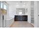 Bright bathroom featuring a soaking tub, double vanity, and entry to walk-in closet at 25616 N 148Th Dr, Surprise, AZ 85387