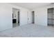 Spacious bedroom with gray carpet leading to the ensuite bathroom and walk-in closet at 25616 N 148Th Dr, Surprise, AZ 85387