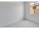 Cozy bedroom with neutral carpet, white walls, and natural light from the window at 25616 N 148Th Dr, Surprise, AZ 85387