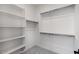 Walk-in closet with white shelving and metal rods to maximize storage at 25616 N 148Th Dr, Surprise, AZ 85387