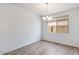 Empty dining room featuring a modern chandelier and wood-look tile flooring at 25616 N 148Th Dr, Surprise, AZ 85387