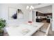 Contemporary dining room featuring modern chandelier, artwork and seating for six at 25616 N 148Th Dr, Surprise, AZ 85387