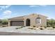 Inviting single-story home showcases desert landscaping, tile roof, a covered porch, and a two-car garage at 25616 N 148Th Dr, Surprise, AZ 85387