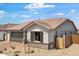 Charming single-story home featuring a brick-accented facade, desert landscaping and a two-car garage at 25616 N 148Th Dr, Surprise, AZ 85387