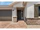 Welcoming front entry with brick accents and a stylish, covered entryway for guests at 25616 N 148Th Dr, Surprise, AZ 85387