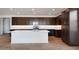 Spacious kitchen with dark cabinets, stainless steel appliances, and a central island at 25616 N 148Th Dr, Surprise, AZ 85387