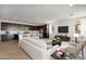 Open concept living space featuring modern furnishings, bright windows, and adjoining kitchen at 25616 N 148Th Dr, Surprise, AZ 85387
