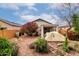 Backyard featuring desert landscaping, a privacy wall and a covered patio area at 26145 W Runion Dr, Buckeye, AZ 85396