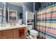 Bathroom featuring a vanity, toilet with storage, and patterned shower curtain at 26145 W Runion Dr, Buckeye, AZ 85396