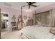 Bedroom with a four poster bed, neutral tones, a ceiling fan and plenty of natural light at 26145 W Runion Dr, Buckeye, AZ 85396