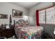 Cozy bedroom with a metal frame bed and bright colorful bedding at 26145 W Runion Dr, Buckeye, AZ 85396