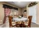 Dining room features a round table with four chairs, a large window and neutral paint at 26145 W Runion Dr, Buckeye, AZ 85396